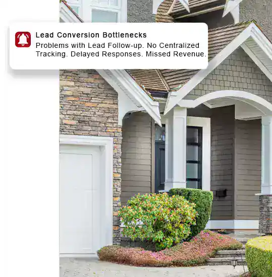 Modern house exterior with stone and siding, lush landscaping, and porch.