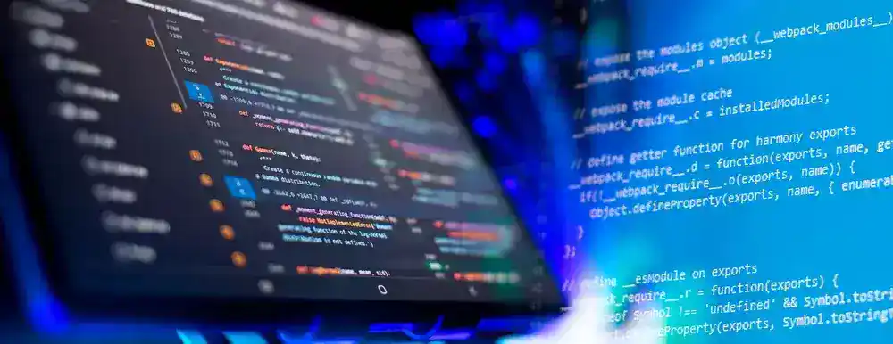 Close-up of computer screen displaying web development code and programming language.